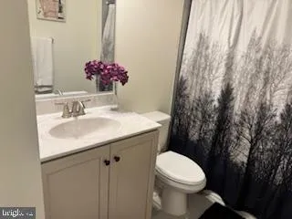 a bathroom with a toilet and a sink