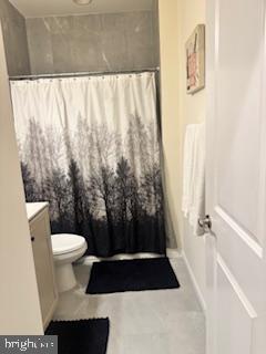 7792 Old Receiver Road Frederick, MD 21702 - Photo 18 of 51 a bathroom with a toilet and a shower curtain