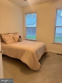 a large bed sitting in a bedroom and table
