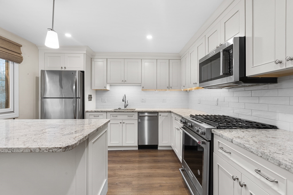 14 Williams Street, Unit C17 Danvers, MA 01923 - Photo 2 of 30 a kitchen with granite countertop stainless steel appliances and wooden cabinets
