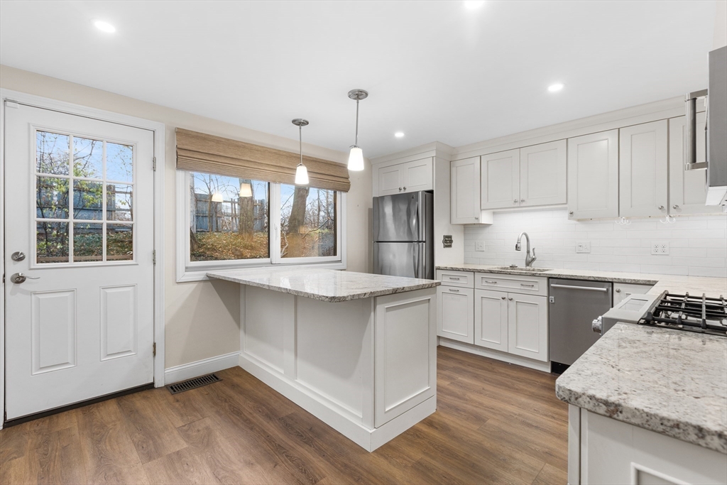 14 Williams Street, Unit C17 Danvers, MA 01923 - Photo 5 of 30 a kitchen with stainless steel appliances granite countertop a stove a sink and a refrigerator