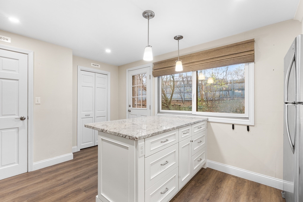 14 Williams Street, Unit C17 Danvers, MA 01923 - Photo 6 of 30 a kitchen with a sink window and wooden floor