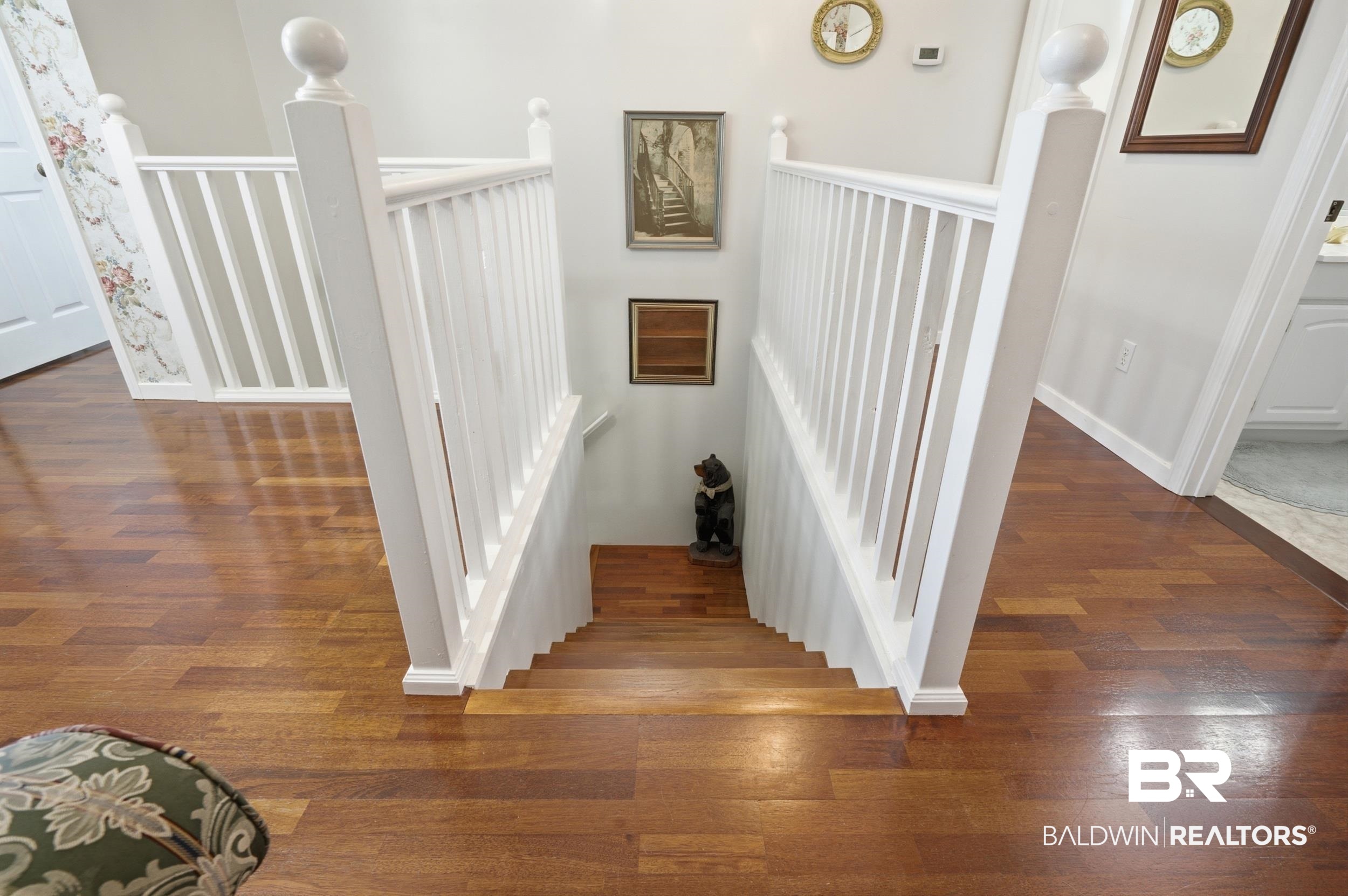 15855 Calvin Richerson Road Bay Minette, AL 36507 - Photo 47 of 83 Hardwood flooring throughout the landing and stairs with white balusters