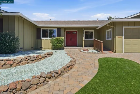 a front view of house with yard outdoor seating and barbeque oven