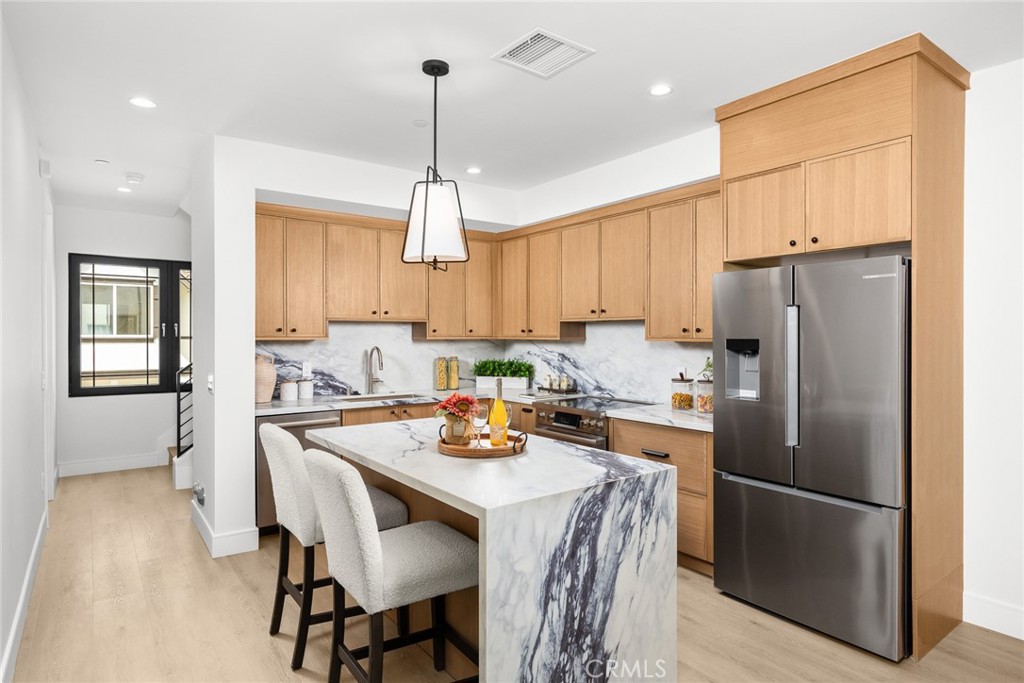 828 Sunset Boulevard, Unit B Arcadia, CA 91007 - Photo 13 of 47 a kitchen with refrigerator a sink and chairs
