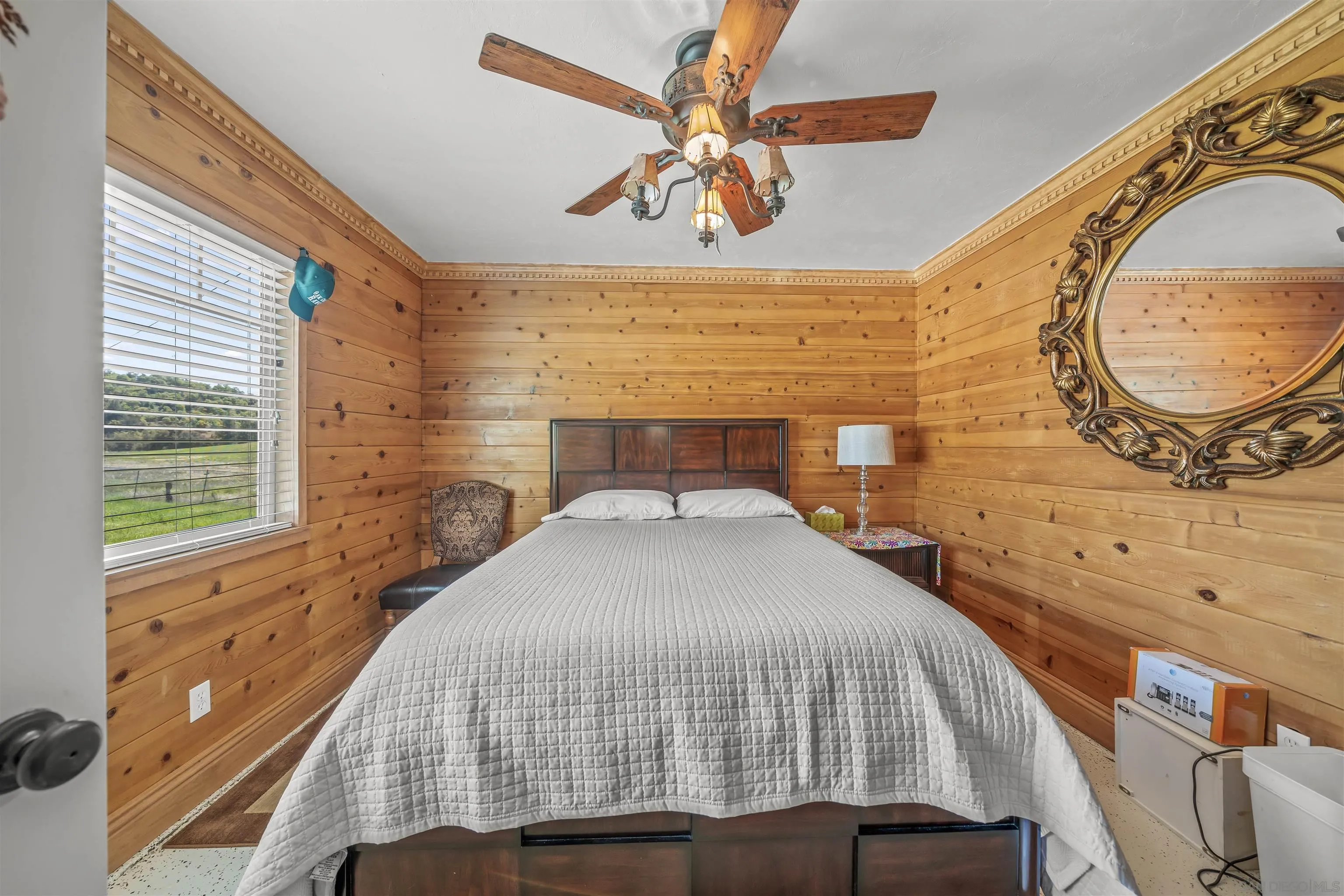 2464 Wynola Road Julian, CA 92036 - Photo 13 of 50 a bedroom with a bed and a chandelier