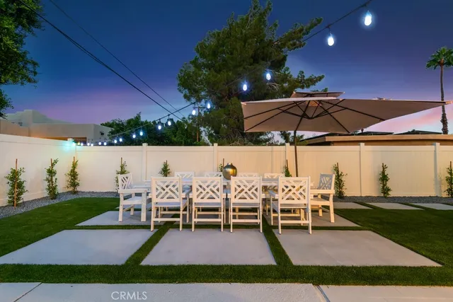 a view of table and chairs under an umbrella
