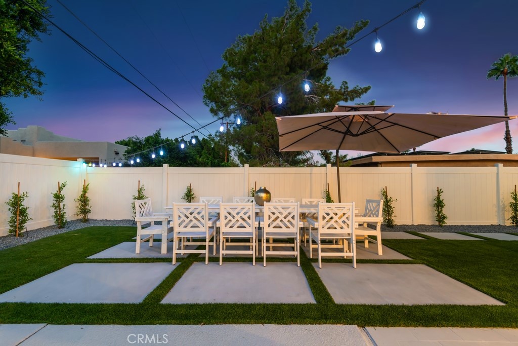 a view of table and chairs under an umbrella