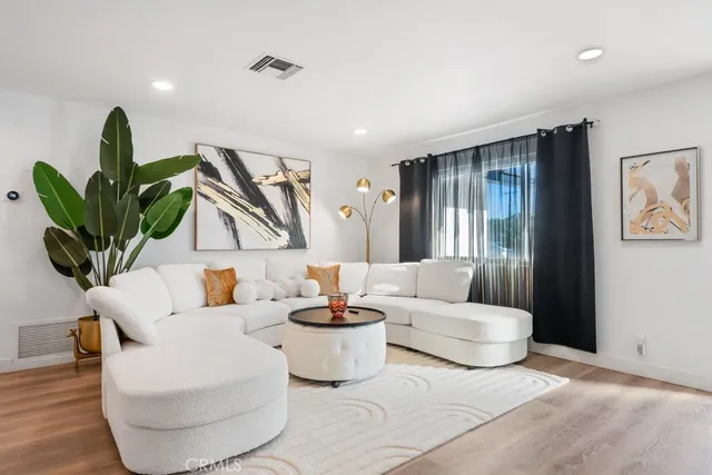 a living room with furniture potted plant and a window