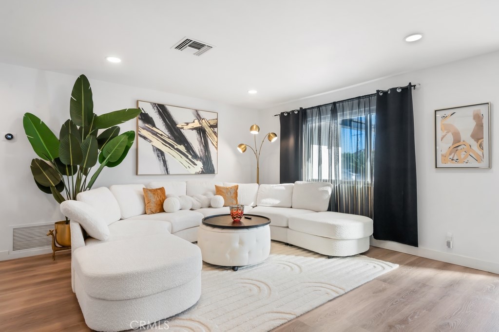 1980 East Rochelle Road Palm Springs, CA 92262 - Photo 11 of 60 a living room with furniture a potted plant and a window