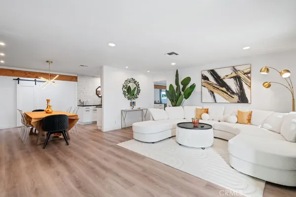 a living room with furniture and a wooden floor
