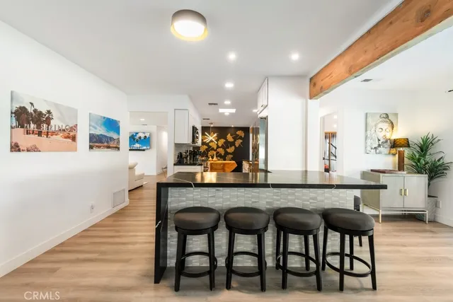 a dining room with furniture a rug and a floor to ceiling window