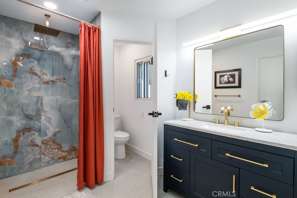 1980 East Rochelle Road Palm Springs, CA 92262 - Photo 26 of 60 a bathroom with a granite countertop sink a toilet and shower