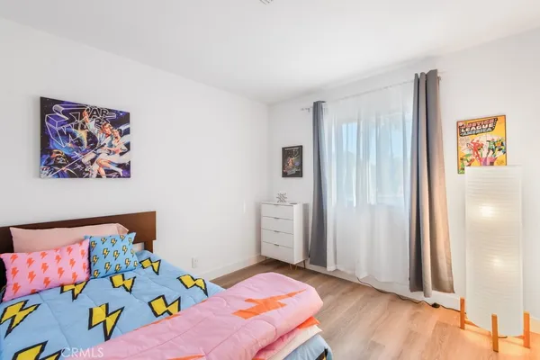 a bedroom with a bed and a potted plant