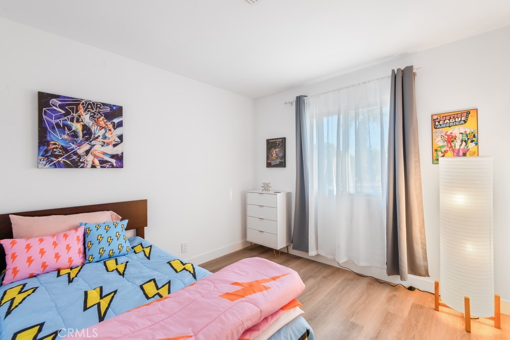 1980 East Rochelle Road Palm Springs, CA 92262 - Photo 28 of 60 a bedroom with a bed and wooden floor