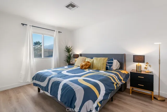 a bedroom with a bed and a potted plant