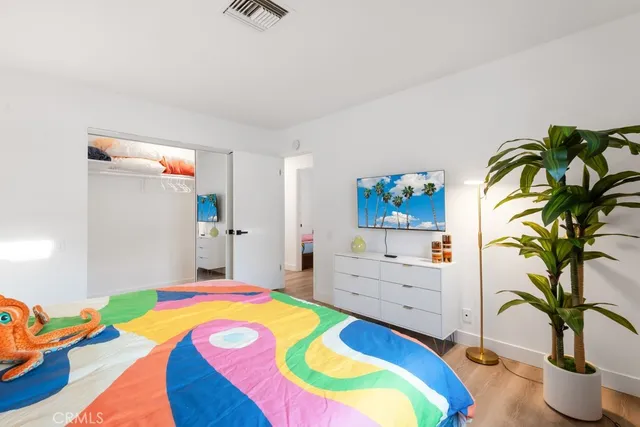 a bedroom with a bed and a dresser in it