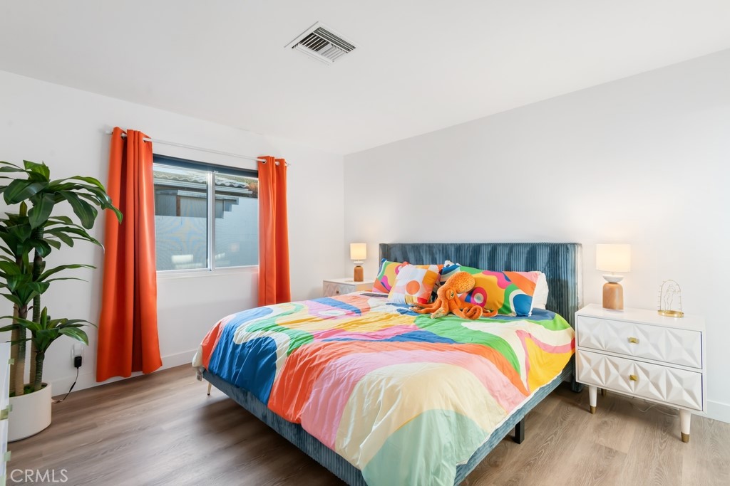 1980 East Rochelle Road Palm Springs, CA 92262 - Photo 33 of 60 a bedroom with a bed and a potted plant