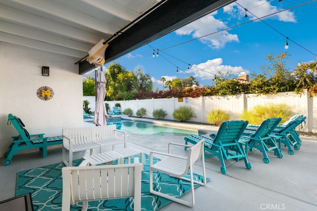 1980 East Rochelle Road Palm Springs, CA 92262 - Photo 38 of 60 a roof deck with table and chairs and potted plants with wooden floor