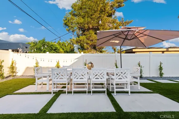 a swimming pool with outdoor seating and yard