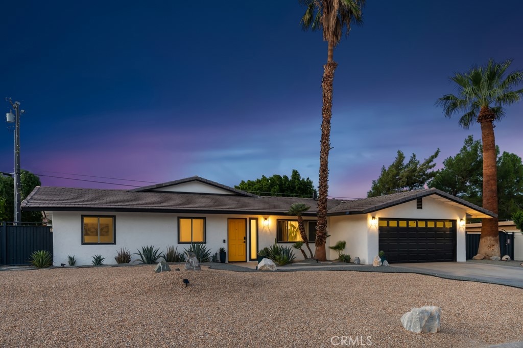 1980 East Rochelle Road Palm Springs, CA 92262 - Photo 50 of 60 a front view of a house with a yard and garage