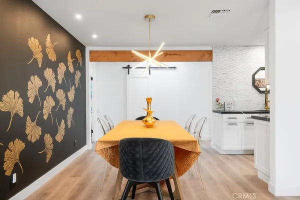 a living room with furniture a potted plant and a window