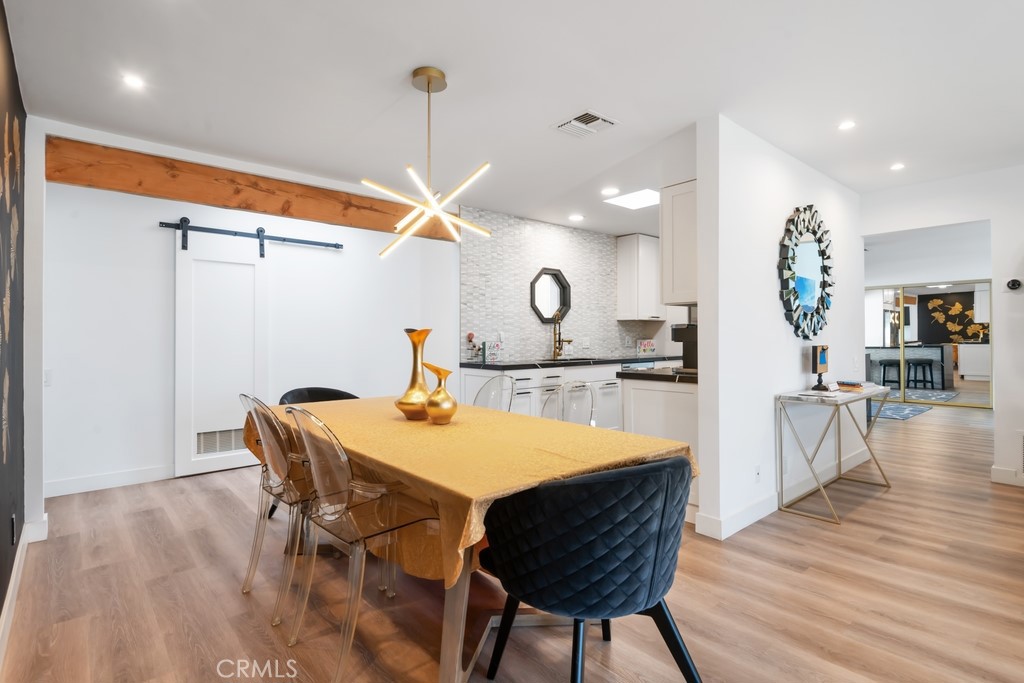 1980 East Rochelle Road Palm Springs, CA 92262 - Photo 9 of 60 a view of a dining room with furniture and wooden floor