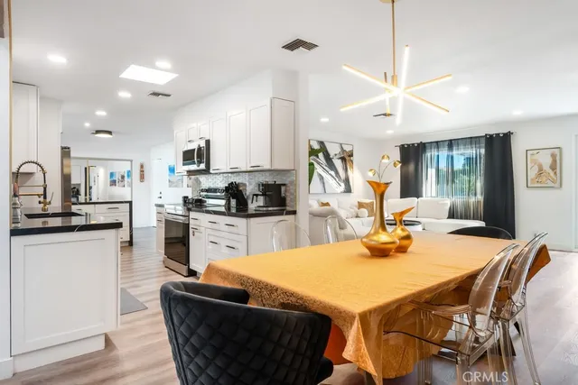 a living room with furniture a potted plant and a window
