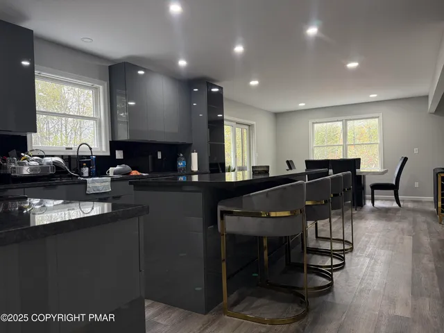 a kitchen with a dining table chairs and white appliances