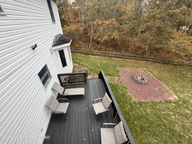 a balcony with wooden floor and outdoor seating