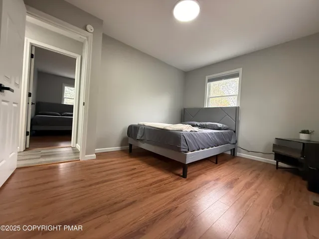 a spacious bedroom with a bed and a window