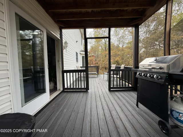 a view of a balcony with furniture and wooden floor