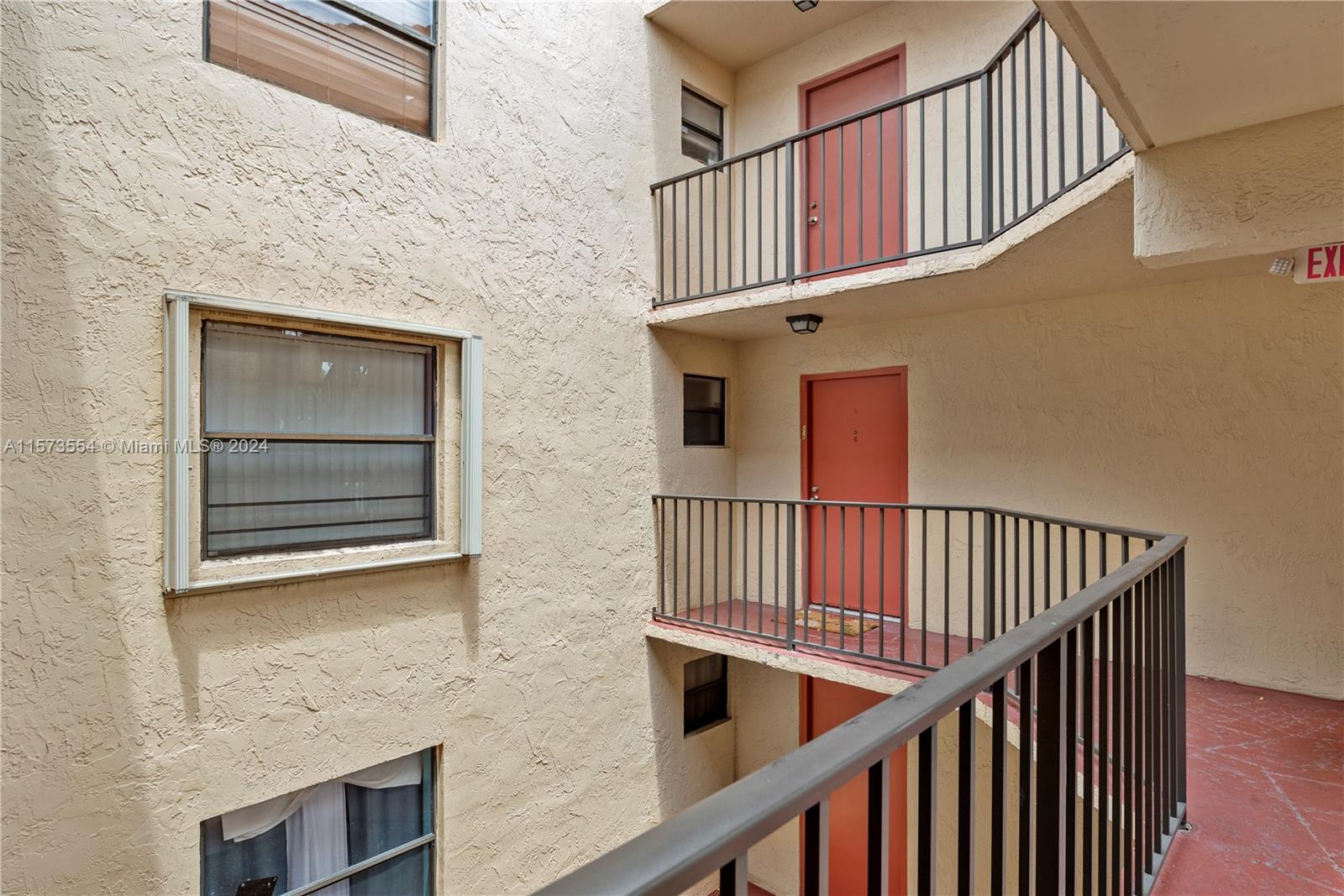 3252 Foxcroft Road, Unit 216 Miramar, FL 33025 - Photo 15 of 16 a view of entryway stairs and hall with wooden floor