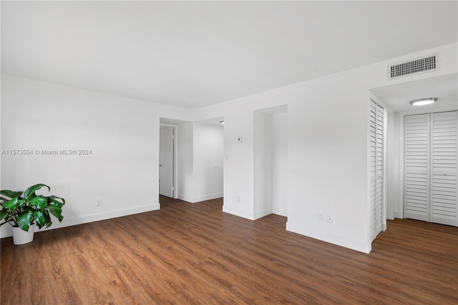 3252 Foxcroft Road, Unit 216 Miramar, FL 33025 - Photo 4 of 16 a view of an empty room with wooden floor