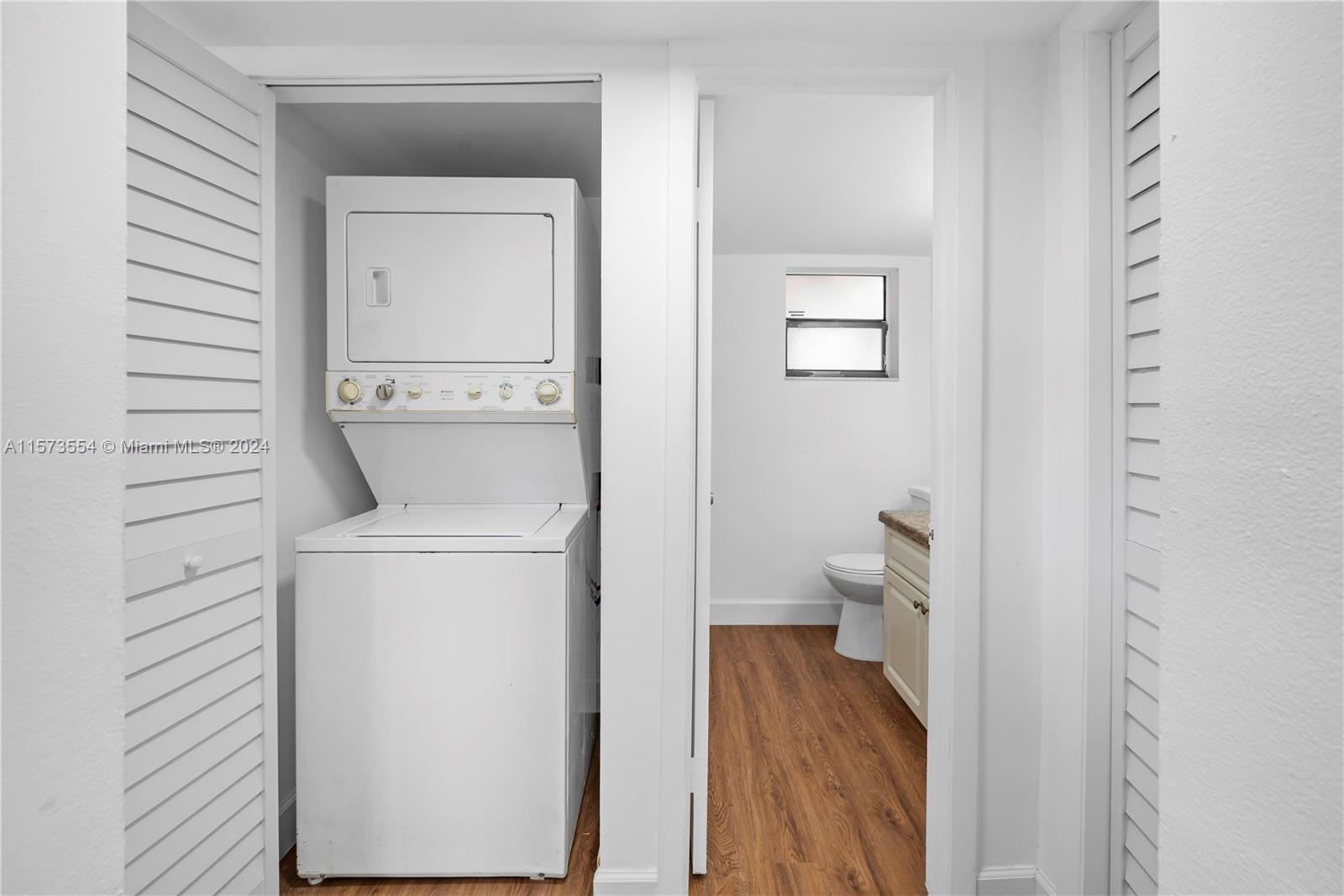 3252 Foxcroft Road, Unit 216 Miramar, FL 33025 - Photo 8 of 16 a room with a washer and dryer