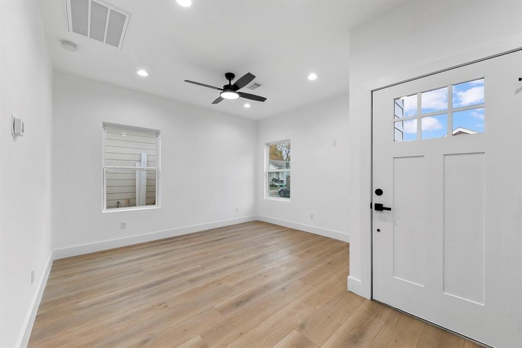 2805 Nettleton Street Houston, TX 77004 - Photo 2 of 9 This bright entryway features sleek wood flooring, a modern ceiling fan, and recessed lighting. Large windows and a stylish front door add to the airy, welcoming atmosphere.