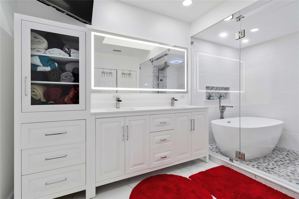 3290 Southwest 131st Terrace Davie, FL 33330 - Photo 14 of 46 a spacious bathroom with a mirror a sink and bathtub