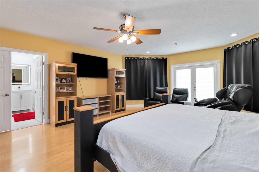 3290 Southwest 131st Terrace Davie, FL 33330 - Photo 28 of 46 a bedroom with a bed and a flat screen tv