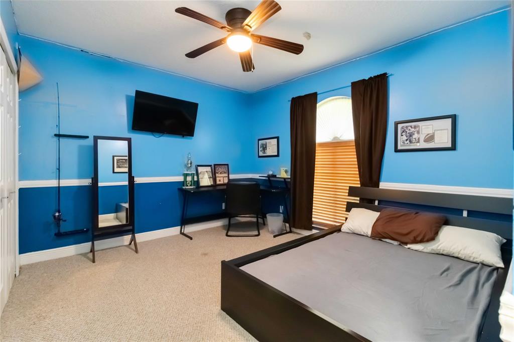 3290 Southwest 131st Terrace Davie, FL 33330 - Photo 29 of 46 a bedroom with a bed and a flat screen tv