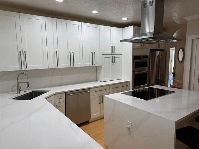 a kitchen with a sink and a refrigerator