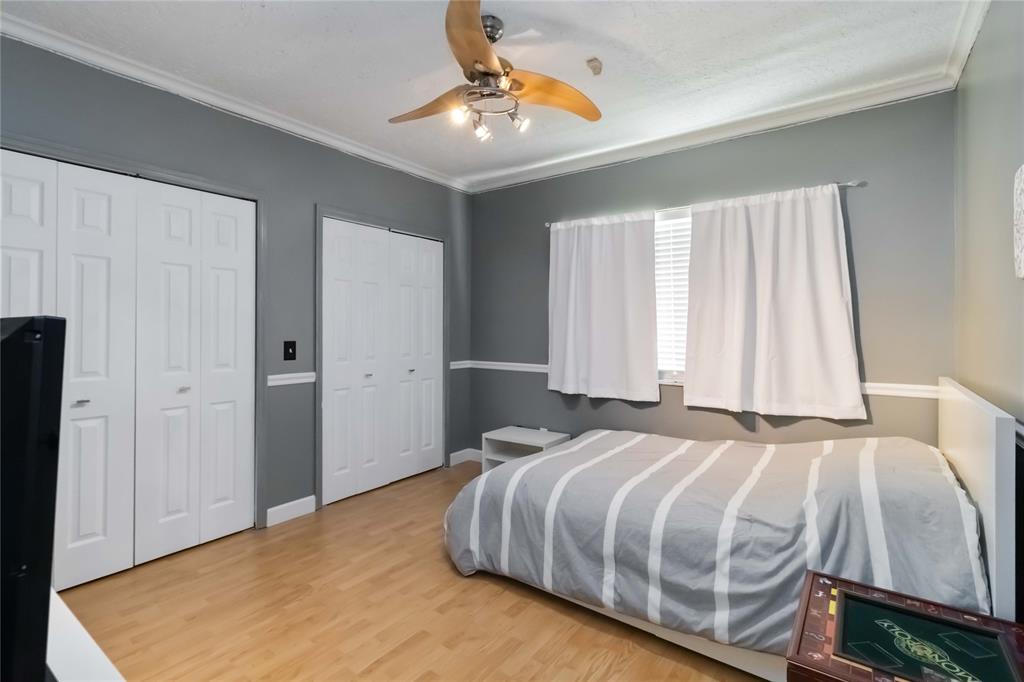 3290 Southwest 131st Terrace Davie, FL 33330 - Photo 31 of 46 a bedroom with a bed and a chandelier