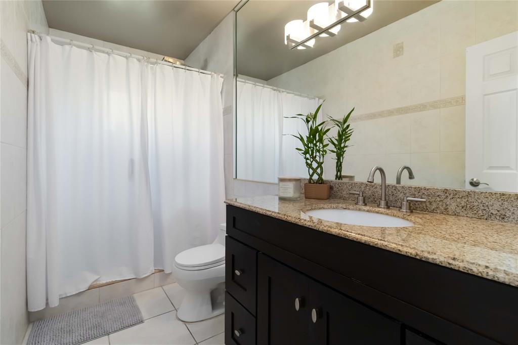 3290 Southwest 131st Terrace Davie, FL 33330 - Photo 34 of 46 a bathroom with a granite countertop sink a toilet and a mirror
