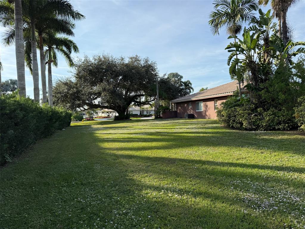 3290 Southwest 131st Terrace Davie, FL 33330 - Photo 41 of 46 a front view of a house with a garden and trees