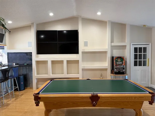 a dining room with furniture and wooden floor