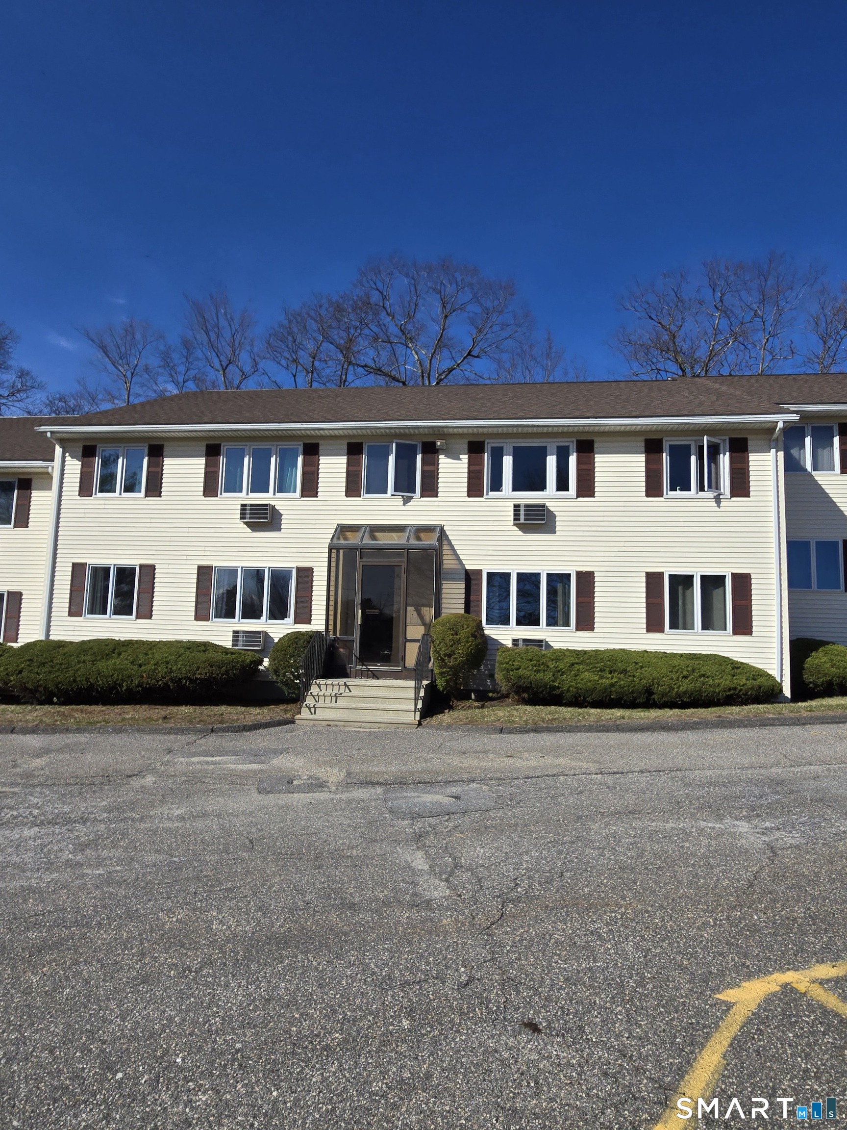 177 Lisle Street, Unit 5 Torrington, CT 06790 - Photo 1 of 18 a view of a big house with a big yard and large trees