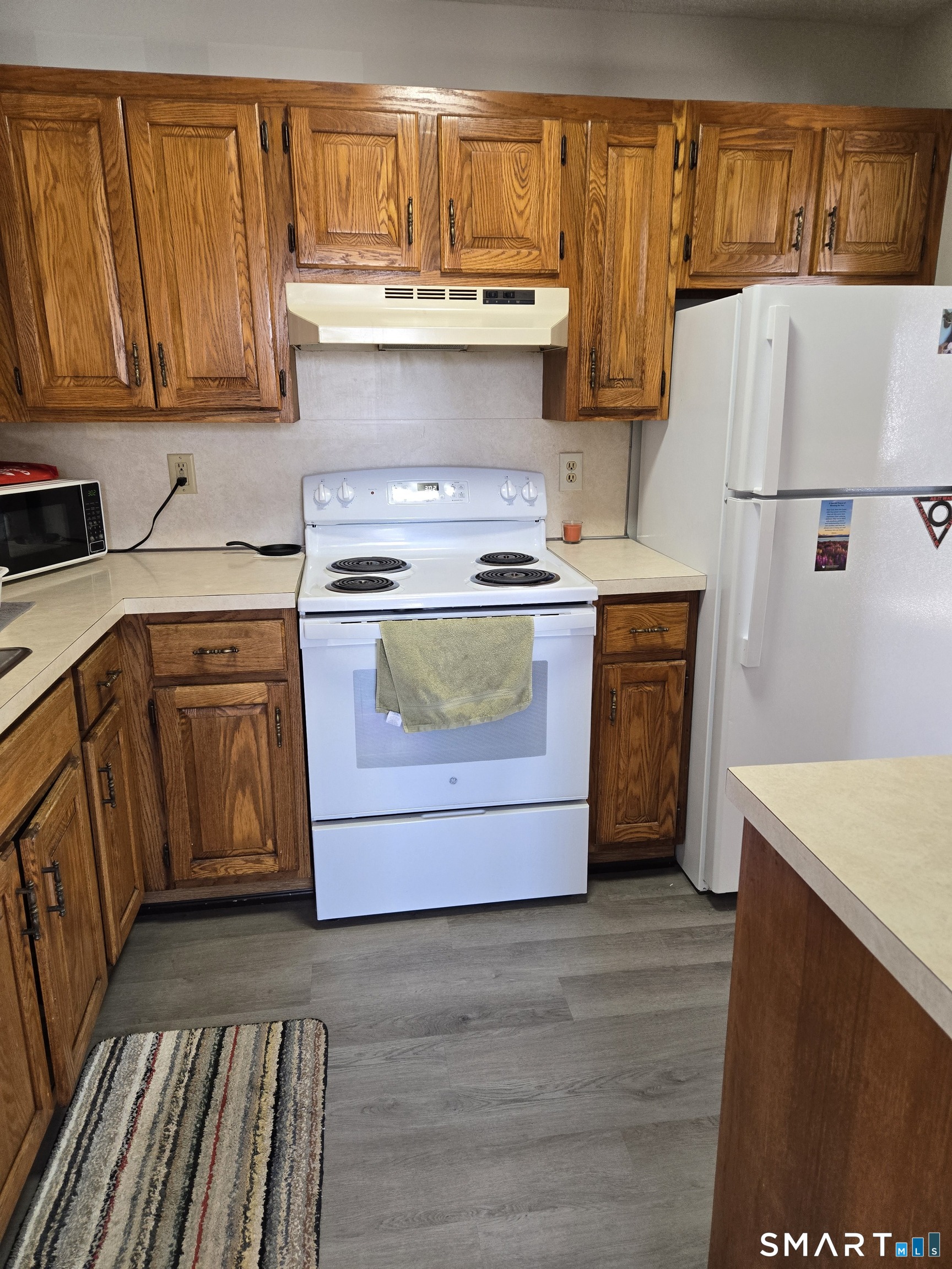 177 Lisle Street, Unit 5 Torrington, CT 06790 - Photo 11 of 18 a kitchen with a stove a sink and a refrigerator