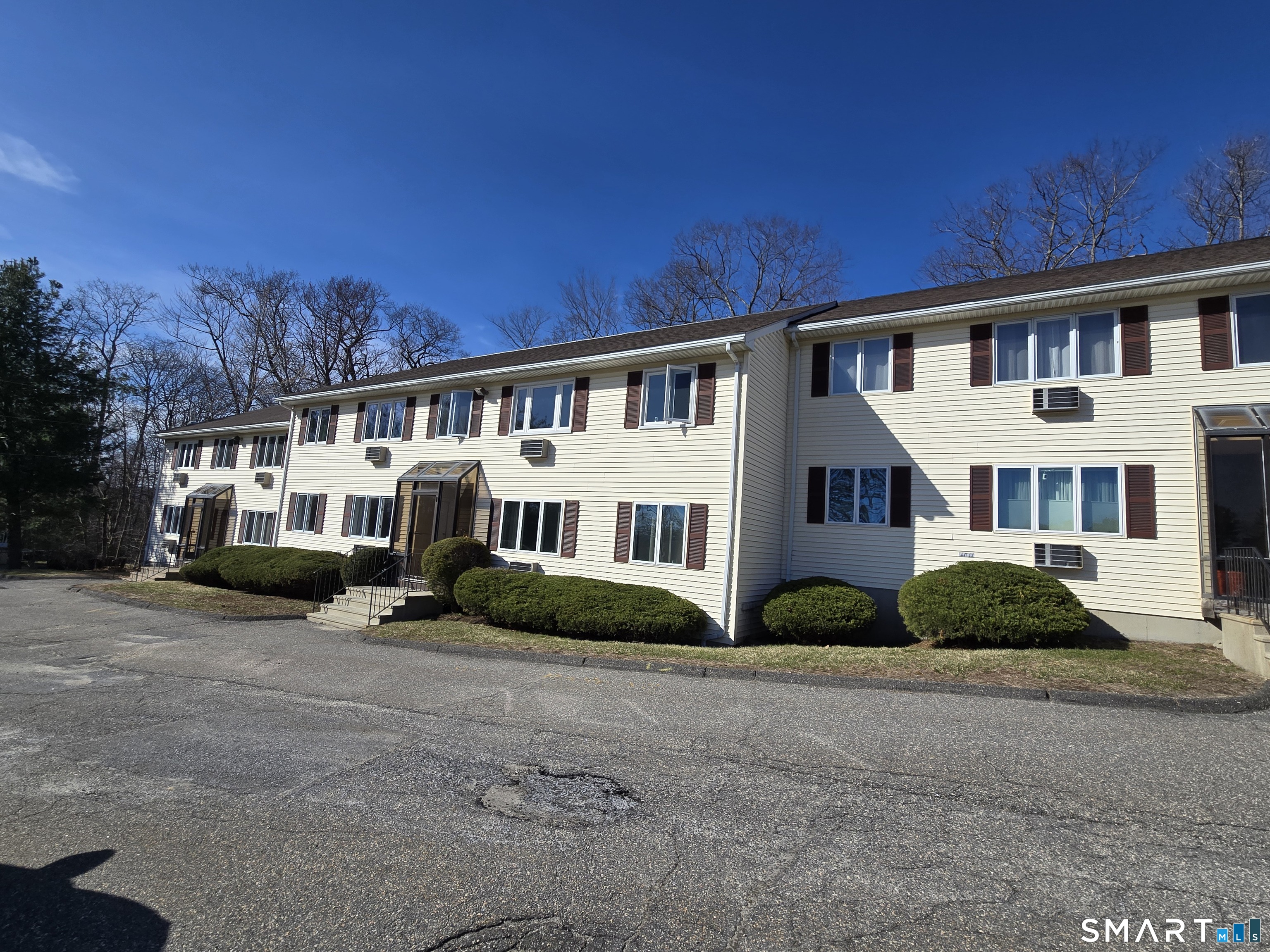 177 Lisle Street, Unit 5 Torrington, CT 06790 - Photo 18 of 18 a front view of a house with a garden