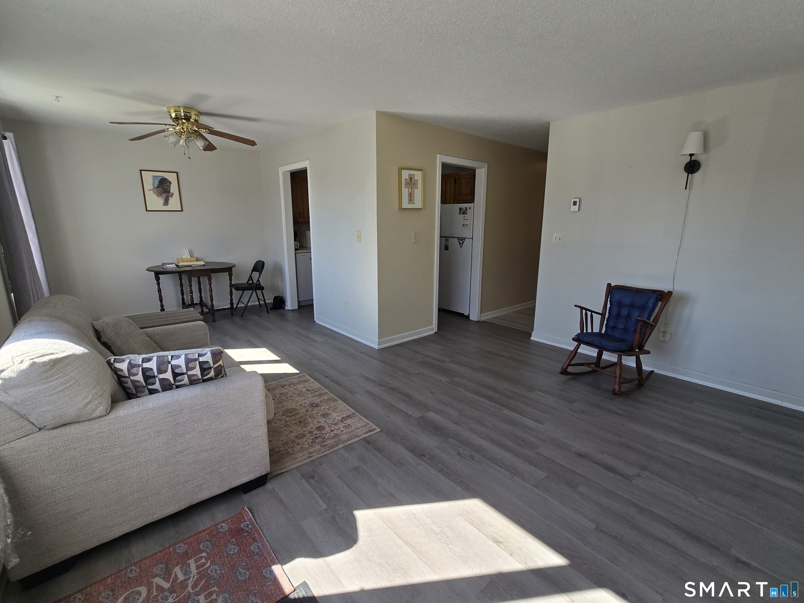 177 Lisle Street, Unit 5 Torrington, CT 06790 - Photo 2 of 18 a living room with furniture and a wooden floor