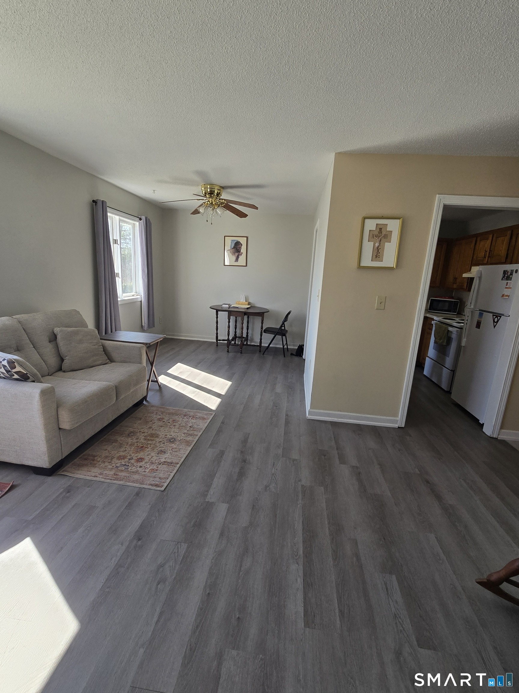 177 Lisle Street, Unit 5 Torrington, CT 06790 - Photo 4 of 18 a living room with furniture and a wooden floor