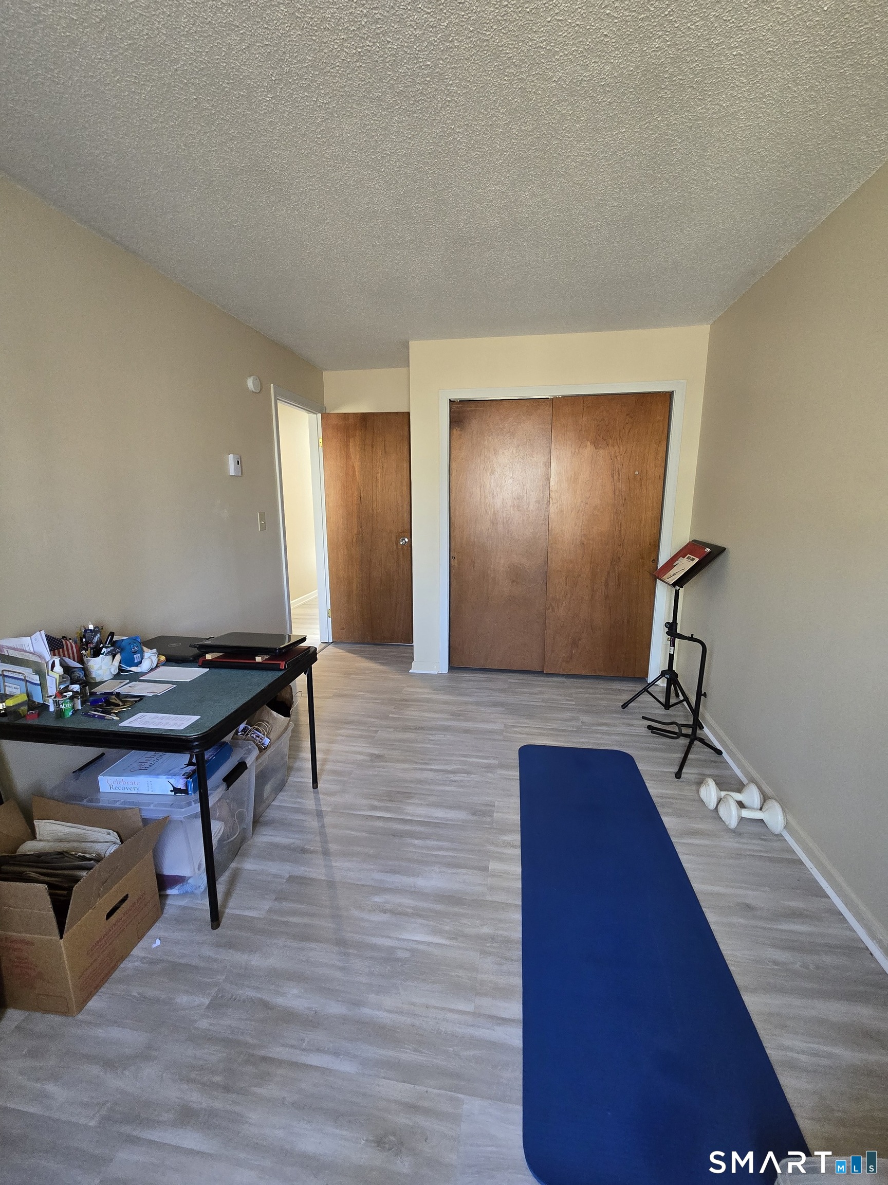 177 Lisle Street, Unit 5 Torrington, CT 06790 - Photo 7 of 18 a room with furniture and wooden floor